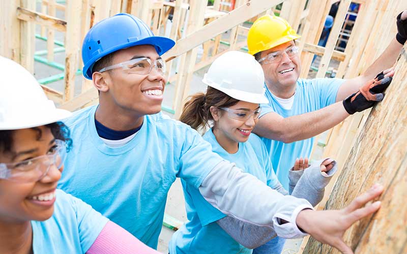 Image of people including teens at an Americorp construction site