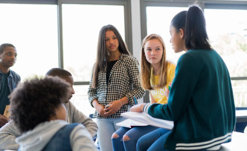 image of teens with one teen leading a group discussion